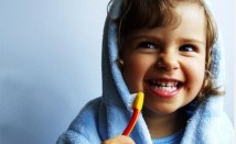 child holding toothbrush