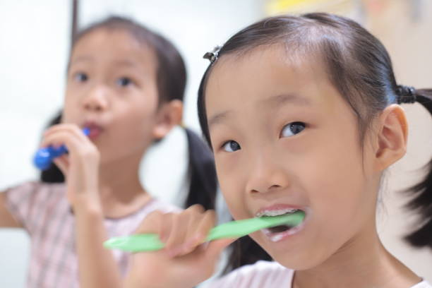 Young girls brushing their teeth in the bathroom